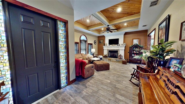 540 Phillips Rd, Sebring, FL 33875 - entryway featuring a ceiling fan, coffered ceiling, wood finished floors, a stone fireplace, and baseboards
