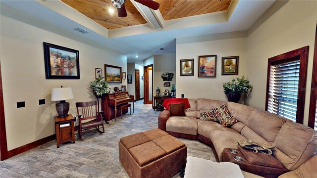 540 Phillips Rd, Sebring, FL 33875 - living area with wood ceiling with exposed beams, ceiling fan, baseboards, a tray ceiling, and stone finish floors