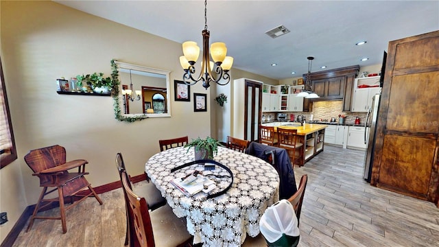 540 Phillips Rd, Sebring, FL 33875 - dining space with a chandelier, light wood-type flooring, baseboards, and recessed lighting