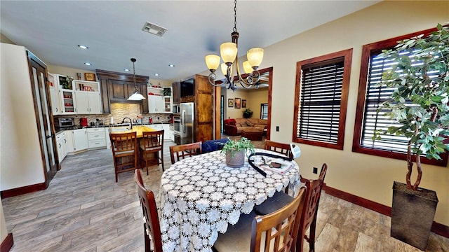 540 Phillips Rd, Sebring, FL 33875 - dining area featuring a chandelier, baseboards, healthy amount of natural light, light wood-style floors, and recessed lighting