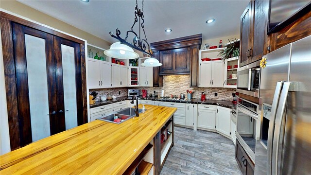 540 Phillips Rd, Sebring, FL 33875 - kitchen featuring open shelves, stainless steel appliances, a sink, tasteful backsplash, and recessed lighting