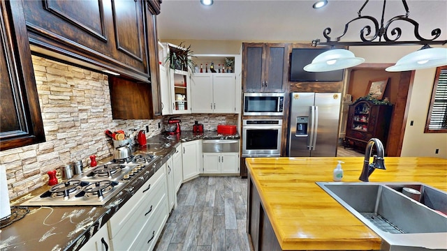 540 Phillips Rd, Sebring, FL 33875 - kitchen with stainless steel appliances, butcher block counters, a sink, a warming drawer, and recessed lighting
