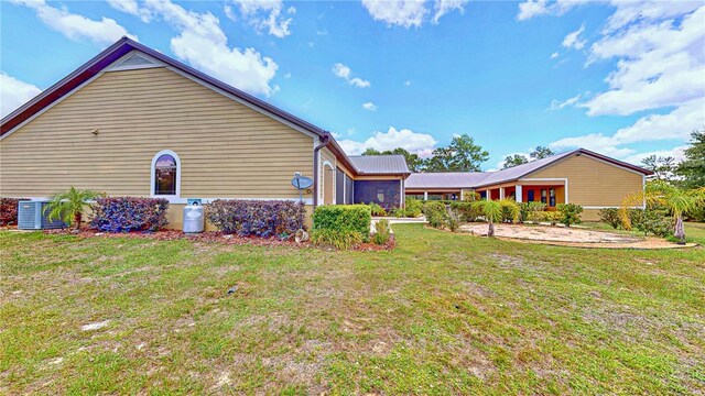 540 Phillips Rd, Sebring, FL 33875 - view of green lawn with a garage and cooling unit