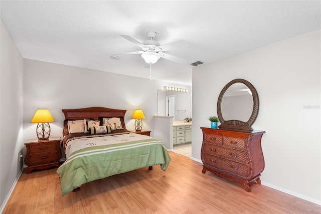 703 Magnolia Pl Unit 703, Winter Haven, FL 33884 - bedroom with wood finished floors, baseboards, ensuite bathroom, and ceiling fan