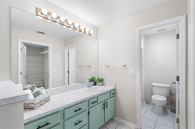 703 Magnolia Pl Unit 703, Winter Haven, FL 33884 - bathroom with vanity, tile patterned flooring, toilet, a textured ceiling, and baseboards