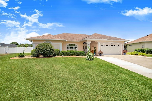 413 Ruby Lake Pl, Winter Haven, FL 33884 - mediterranean / spanish home with an attached garage, driveway, and stucco siding