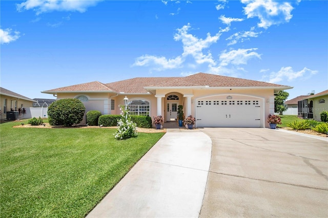 413 Ruby Lake Pl, Winter Haven, FL 33884 - view of front facade with a front lawn, driveway, an attached garage, and stucco siding