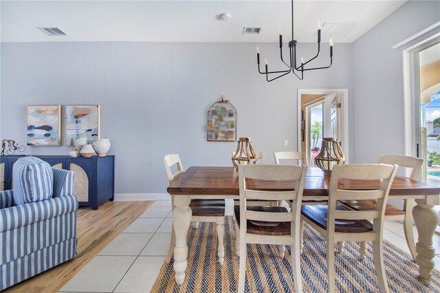 413 Ruby Lake Pl, Winter Haven, FL 33884 - dining area with a chandelier and light wood-style flooring