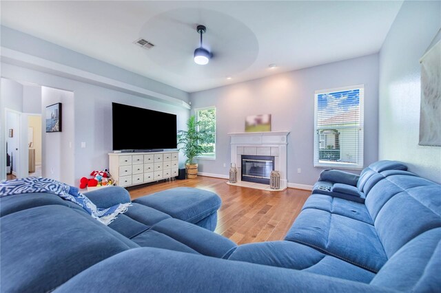 413 Ruby Lake Pl, Winter Haven, FL 33884 - living room with a ceiling fan, wood finished floors, a fireplace, and baseboards