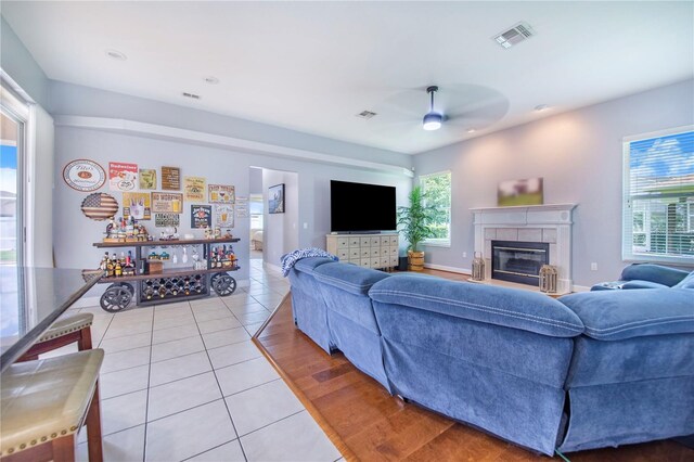 413 Ruby Lake Pl, Winter Haven, FL 33884 - living room featuring ceiling fan, light tile patterned flooring, and a tile fireplace