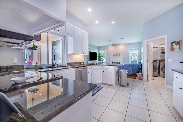 413 Ruby Lake Pl, Winter Haven, FL 33884 - kitchen featuring washing machine and clothes dryer, dishwasher, a peninsula, white cabinetry, and open floor plan