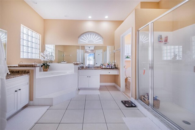 413 Ruby Lake Pl, Winter Haven, FL 33884 - bathroom with vanity, a garden tub, a shower stall, tile patterned flooring, and toilet
