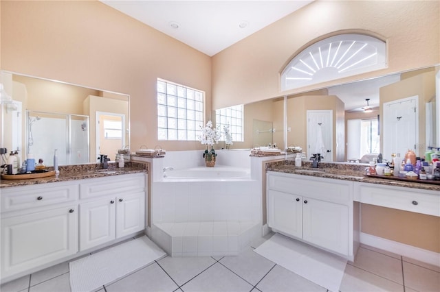 413 Ruby Lake Pl, Winter Haven, FL 33884 - bathroom featuring two vanities, a garden tub, and healthy amount of natural light