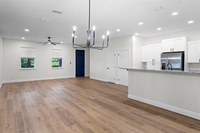 2052 W Elliott St, Lakeland, FL 33805 - unfurnished living room featuring recessed lighting, light wood finished floors, a chandelier, ceiling fan, and baseboards