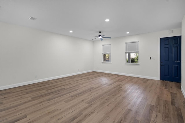 2052 W Elliott St, Lakeland, FL 33805 - empty room with a ceiling fan, recessed lighting, wood finished floors, and baseboards