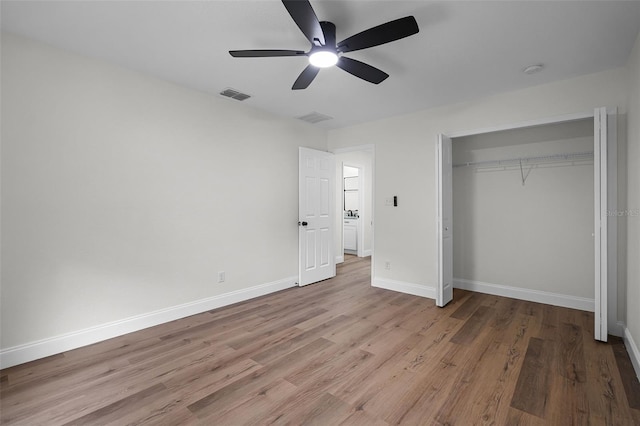 2052 W Elliott St, Lakeland, FL 33805 - unfurnished bedroom featuring wood finished floors, baseboards, a closet, and ceiling fan