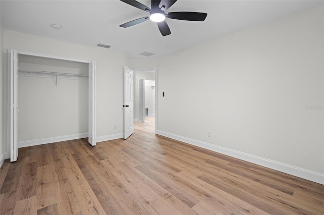 2052 W Elliott St, Lakeland, FL 33805 - unfurnished bedroom with wood finished floors, baseboards, a closet, and ceiling fan