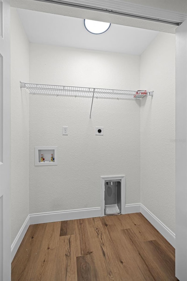 2052 W Elliott St, Lakeland, FL 33805 - laundry room featuring hookup for an electric dryer, washer hookup, wood finished floors, and baseboards