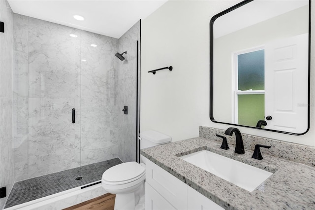 2052 W Elliott St, Lakeland, FL 33805 - bathroom with toilet, a shower stall, vanity, recessed lighting, and wood finished floors