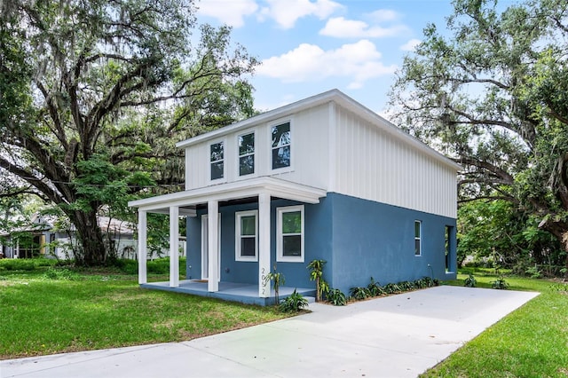 2052 W Elliott St, Lakeland, FL 33805 - view of front of home featuring a porch, a front lawn, and stucco siding