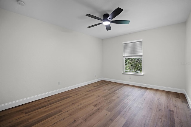2052 W Elliott St, Lakeland, FL 33805 - empty room featuring baseboards, wood finished floors, a smoke detector, and a ceiling fan