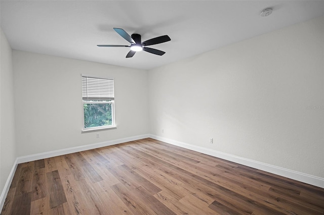 2052 W Elliott St, Lakeland, FL 33805 - empty room with wood finished floors, a smoke detector, ceiling fan, and baseboards