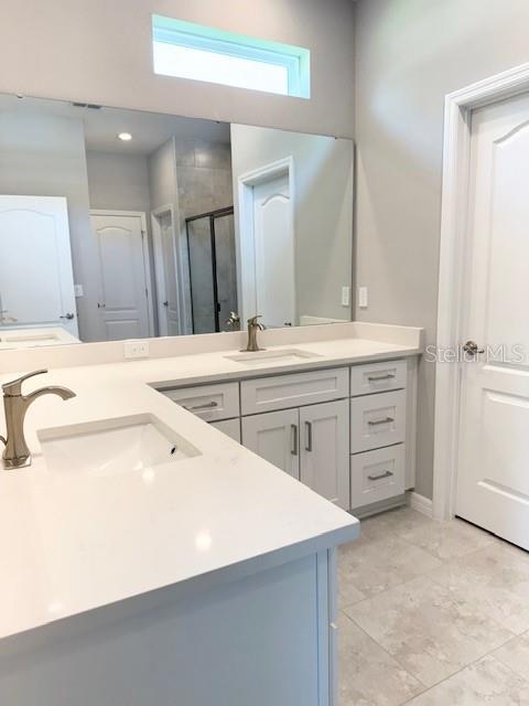 4956 San Lorenzo Dr, Sebring, FL 33872 - full bathroom with double vanity and a shower stall