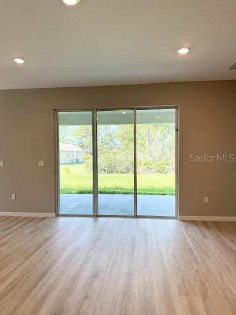 4956 San Lorenzo Dr, Sebring, FL 33872 - empty room with light wood-style floors, baseboards, and recessed lighting