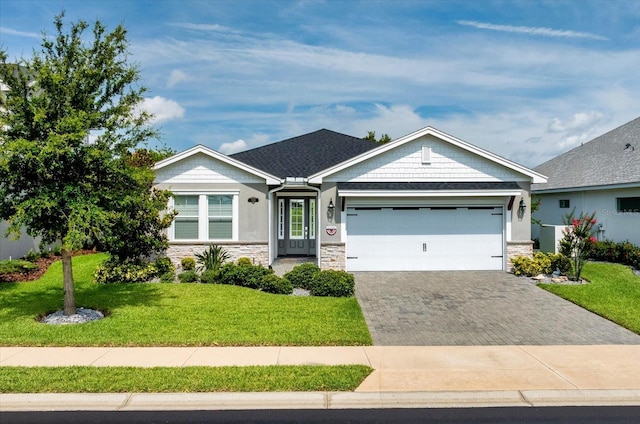 505 Adams View Ln, Auburndale, FL 33823 - view of front of property featuring stone siding, an attached garage, driveway, and a front lawn