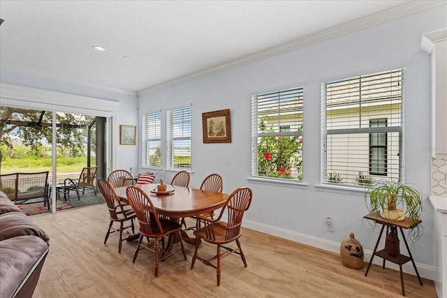 505 Adams View Ln, Auburndale, FL 33823 - dining space with light wood finished floors, crown molding, and baseboards