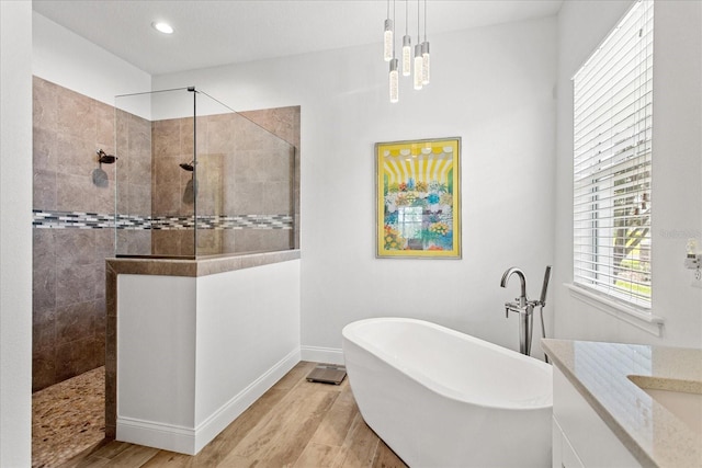 505 Adams View Ln, Auburndale, FL 33823 - full bathroom with a freestanding tub, wood finished floors, a walk in shower, baseboards, and recessed lighting