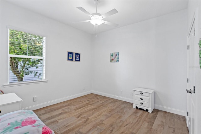 505 Adams View Ln, Auburndale, FL 33823 - unfurnished bedroom featuring multiple windows, light wood-style flooring, baseboards, and a ceiling fan