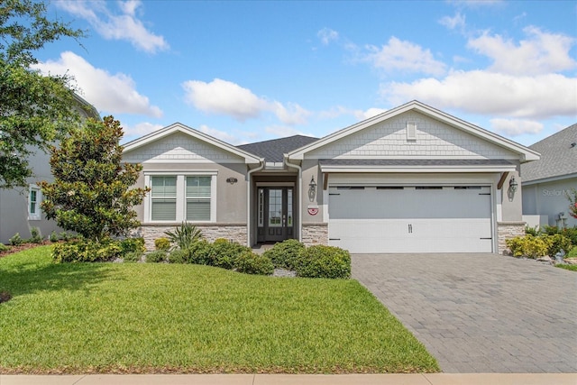 505 Adams View Ln, Auburndale, FL 33823 - craftsman inspired home with stone siding, a garage, a front yard, and decorative driveway