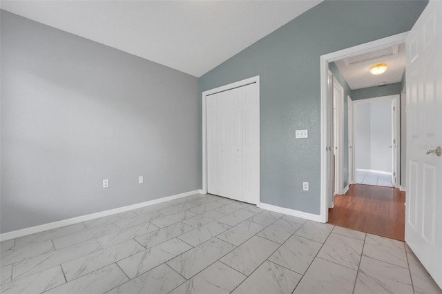 362 Lake Daisy Cir, Winter Haven, FL 33884 - unfurnished bedroom with light marble finish flooring, a closet, baseboards, and lofted ceiling