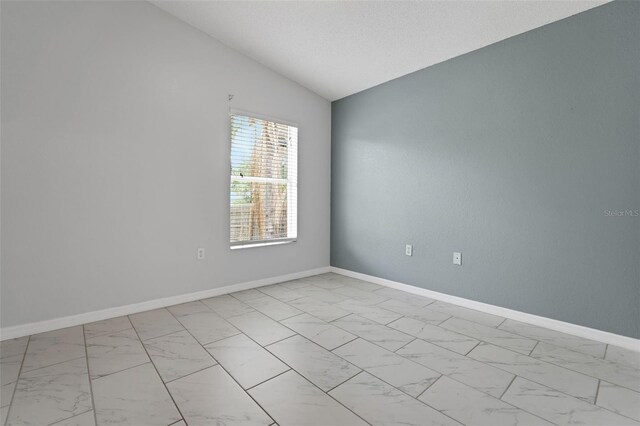362 Lake Daisy Cir, Winter Haven, FL 33884 - empty room featuring light marble finish flooring, lofted ceiling, and baseboards