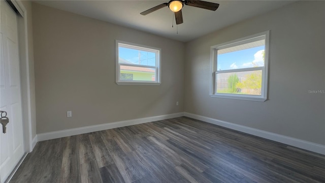 1735 Council Dr, Sun City Center, FL 33573 - spare room with dark wood-style flooring, a ceiling fan, and baseboards