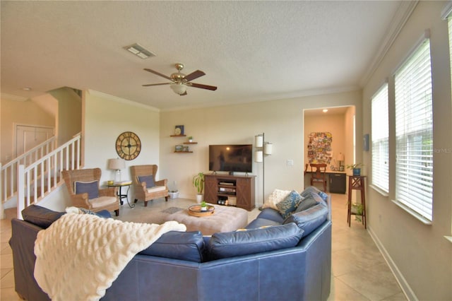 1433 Bunker Dr, Davenport, FL 33896 - living area with light tile patterned floors, a ceiling fan, stairway, crown molding, and baseboards