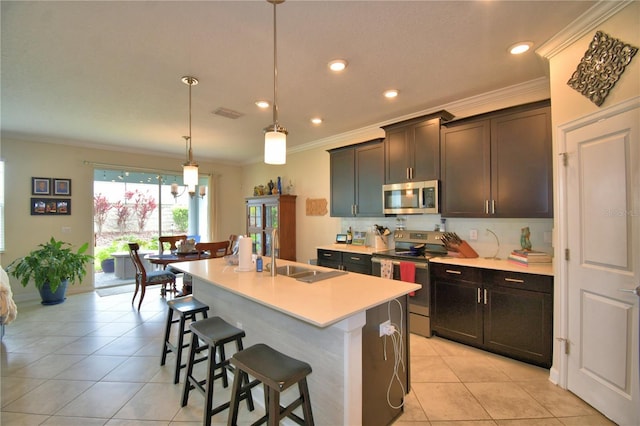 1433 Bunker Dr, Davenport, FL 33896 - kitchen with appliances with stainless steel finishes, a sink, crown molding, light tile patterned floors, and recessed lighting