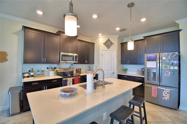 1433 Bunker Dr, Davenport, FL 33896 - kitchen featuring appliances with stainless steel finishes, light tile patterned floors, a sink, a breakfast bar area, and ornamental molding