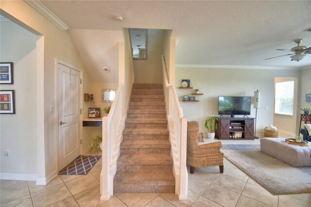 1433 Bunker Dr, Davenport, FL 33896 - stairs featuring crown molding, a ceiling fan, tile patterned flooring, and baseboards