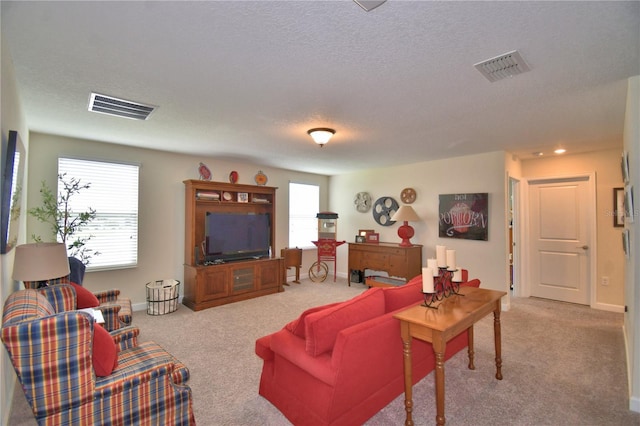 1433 Bunker Dr, Davenport, FL 33896 - living room featuring light carpet, a textured ceiling, and baseboards