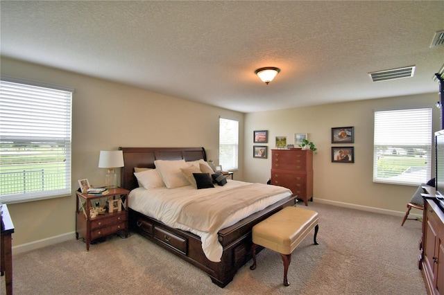 1433 Bunker Dr, Davenport, FL 33896 - bedroom with light colored carpet, a textured ceiling, and baseboards