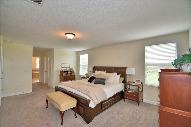 1433 Bunker Dr, Davenport, FL 33896 - bedroom featuring light carpet, a textured ceiling, and baseboards