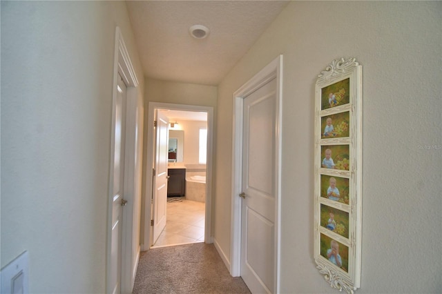 1433 Bunker Dr, Davenport, FL 33896 - hallway with light colored carpet, baseboards, and light tile patterned flooring