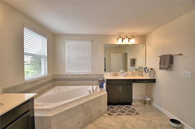 1433 Bunker Dr, Davenport, FL 33896 - bathroom with vanity, a garden tub, tile patterned floors, a textured ceiling, and baseboards