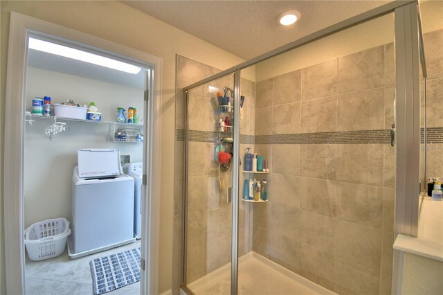 1433 Bunker Dr, Davenport, FL 33896 - bathroom featuring washer and clothes dryer, a shower stall, recessed lighting, and a textured ceiling