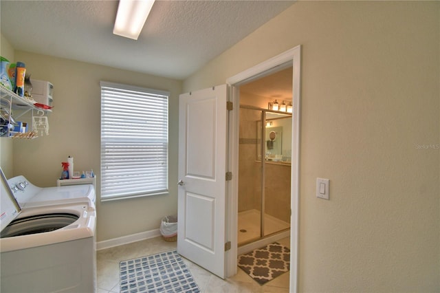 1433 Bunker Dr, Davenport, FL 33896 - laundry room with washer / dryer, a textured ceiling, baseboards, and light tile patterned floors