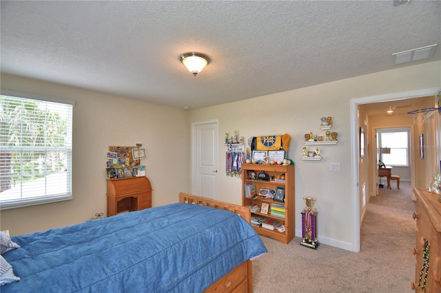 1433 Bunker Dr, Davenport, FL 33896 - bedroom with light carpet, a textured ceiling, and baseboards