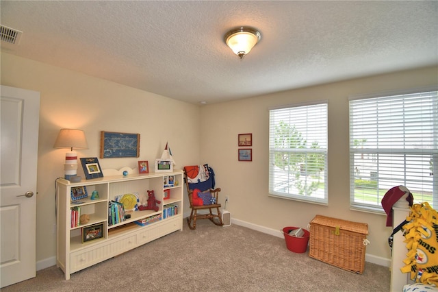 1433 Bunker Dr, Davenport, FL 33896 - recreation room featuring carpet, a textured ceiling, and baseboards