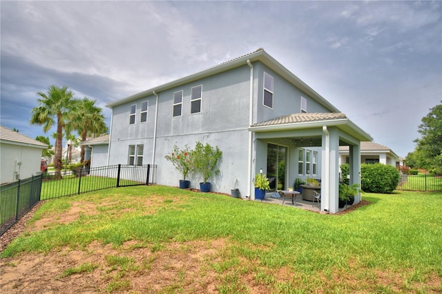 1433 Bunker Dr, Davenport, FL 33896 - rear view of property with stucco siding and a patio